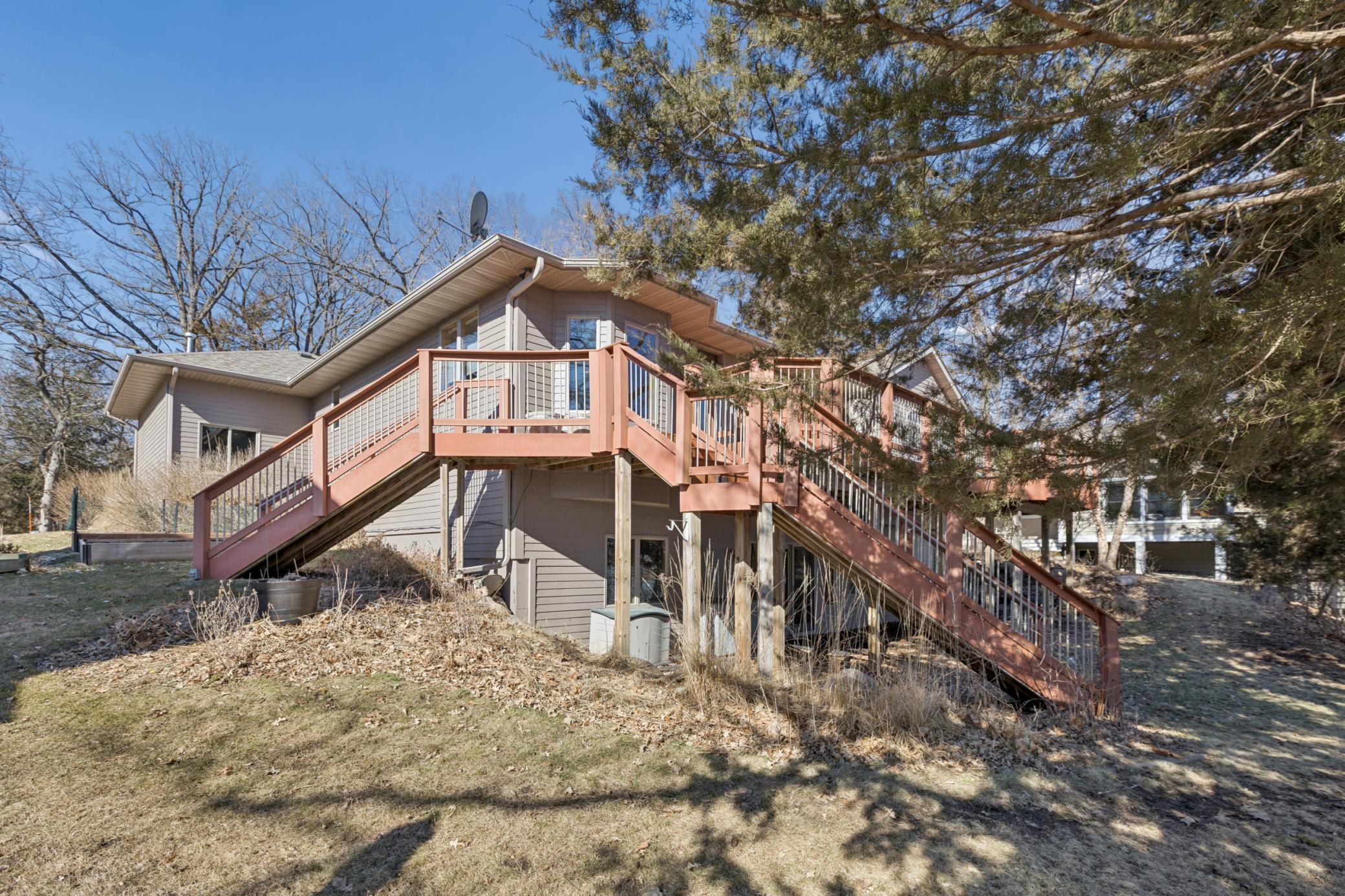 As you walk around the side of the garage you are greeted by stairs leading up to the lakeside deck. Perfect for entertaining guests without going through the house.