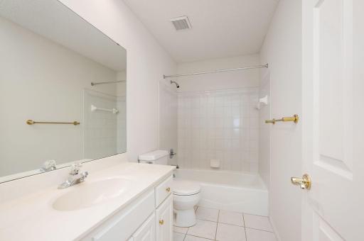 Additional Full Bathroom on main with tile floor and tile surround