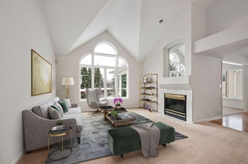 Main Floor Living Room has vaulted ceilings, gas fireplace and open to formal dining room