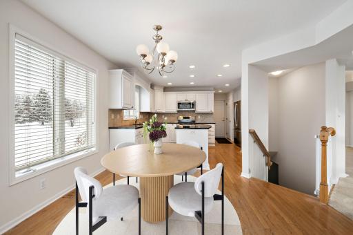 Updated kitchen with granite countertops, tile backsplash, center island, hardwood floors, wine refrigerator and breakfast bar!