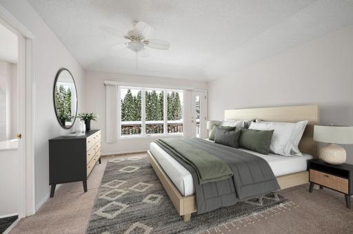 Main Floor Primary Suite has tray vaulted ceiling, access to deck, separate jetted tub and walk-in shower, tile floors, walk-in closet and recessed lighting