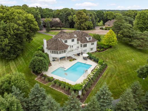 Set on a picturesque lot with pretty views, perennials and shrubs gracing the pool.