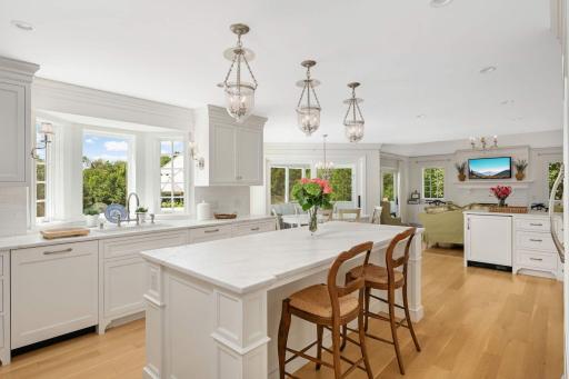 Off the kitchen there is a bar area with extra glass display shelves for barware, the breakfast area, porch and family room.