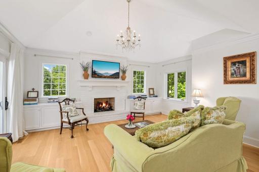 The family room has been thoughtfully enhanced with new windows on either side of the fireplace, which was once built ins. The lower cabinets still provide plenty of pull out cabinet storage.