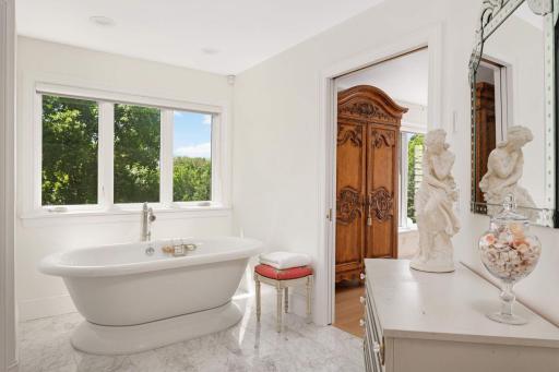 The soaking tub is positioned under the large window with extremely private views!