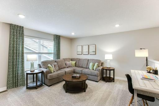 Upper-level family room/game room means no more fighting over the TV! Spread out and relax, leave out your games, puzzles, and toys! Photo of model home, colors and finishes will vary.