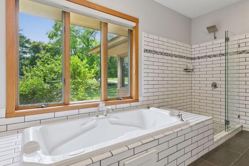 A deep air bathtub offers a place to unwind, while the spacious dual-bowl vanity gives both partners room to get ready without bumping elbows.