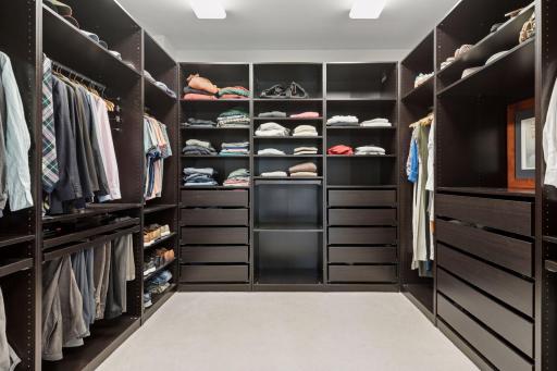 Ample space and tailored storage solutions make this primary closet both functional and stylish.