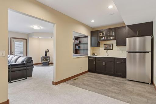 Cabinets provide storage for glassware and bar essentials, while the refrigerator ensures drinks stay perfectly chilled and ready to serve.