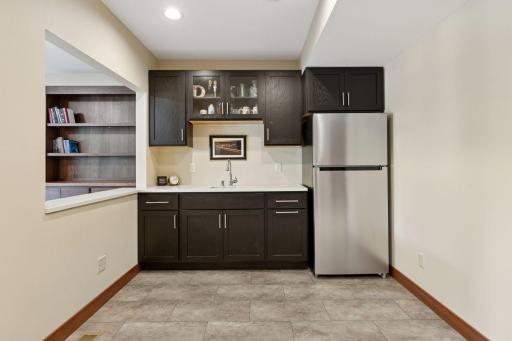 Designed for effortless entertaining, the lower level wet bar offers ample counter space for mixing cocktails and laying out appetizers.