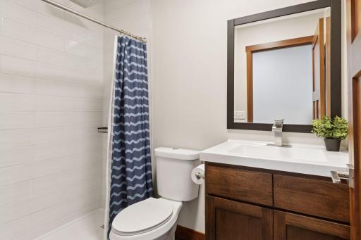 This bathroom is ideal for guests, pool days, or a quick rinse after the sauna.