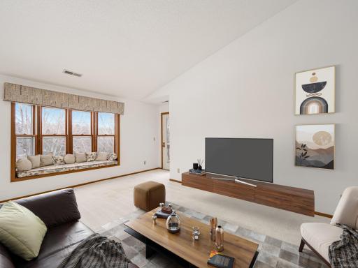 Virtually staged living room with vaulted ceiling.
