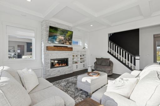 The great room with its stone fireplace offers the perfect retreat.