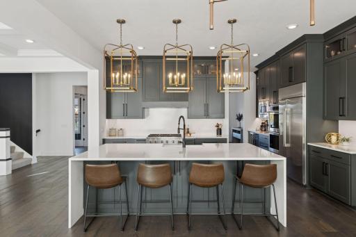 This thoughtfully designed kitchen is a chef's dream! Abundant Storage - Expansive Island - High-End Appliances - Beverage Refrigerator - Coffee Bar - Pantry - Endless space for entertaining!