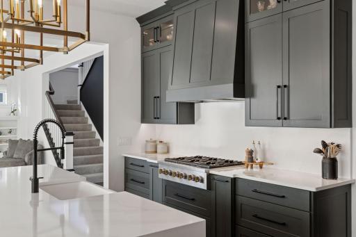 This thoughtfully designed kitchen is a chef's dream! Abundant Storage - Expansive Island - High-End Appliances - Beverage Refrigerator - Coffee Bar - Pantry - Endless space for entertaining!