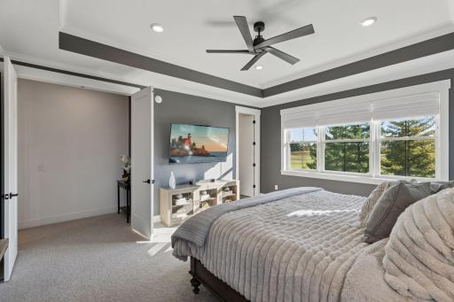 The upper level offers a luxurious primary suite with spa-inspired bath.