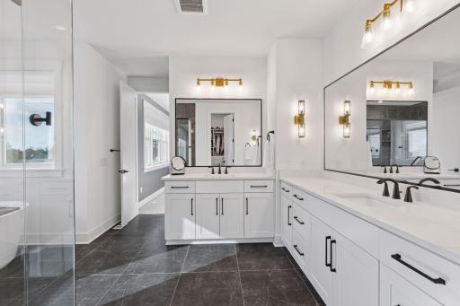The upper level offers a luxurious primary suite with spa-inspired bath including a freestanding tub, in-floor heat, walk-in shower, and dual vanities; a sanctuary of relaxation after a day on the course.