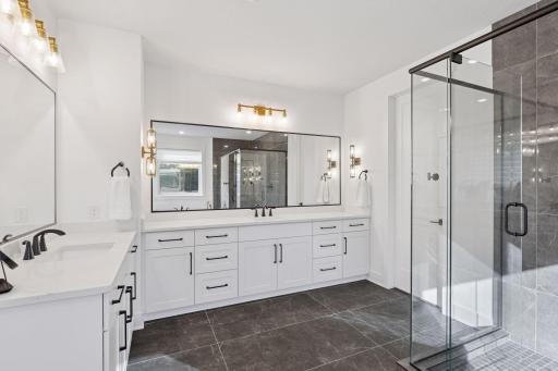 The upper level offers a luxurious primary suite with spa-inspired bath including a freestanding tub, in-floor heat, walk-in shower, and dual vanities; a sanctuary of relaxation after a day on the course.