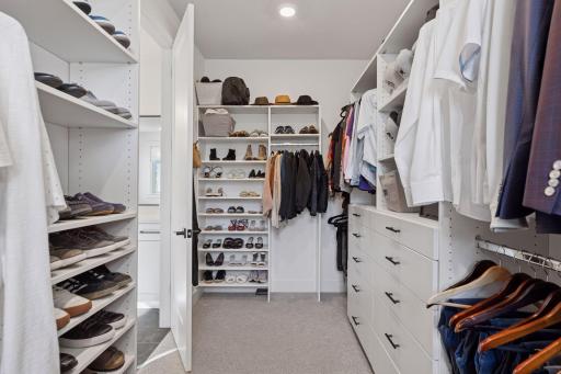 The primary walk-In closet with custom shelving for meticulous organization makes getting ready a breeze!