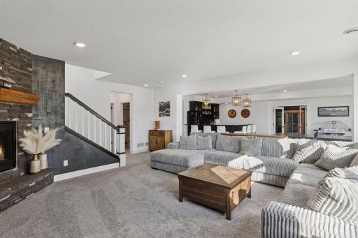 The designer details continue throughout the lower level with an entertainment area that rivals a private club complete with a custom wet bar, gaming space, and access to the beautifully landscaped backyard.