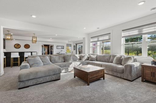 The designer details continue throughout the lower level with an entertainment area that rivals a private club complete with a custom wet bar, gaming space, and access to the beautifully landscaped backyard.