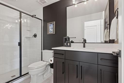 The beautifully designed 3/4 lower level bathroom.