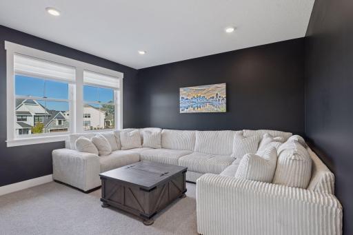 The upper level bonus room offers flexible space that could easily serve as a playroom, homework hub, or private family lounge.
