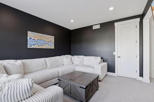 The upper level bonus room offers flexible space that could easily serve as a playroom, homework hub, or private family lounge.