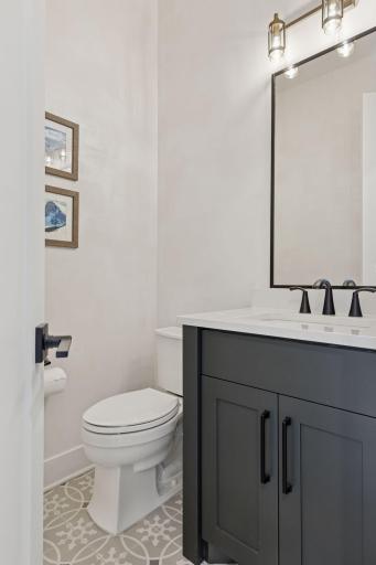 The designer flooring in the half bath, just off the kitchen adds a bit of flair to the space!