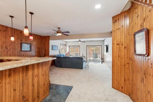 Large family room with natural wood paneling