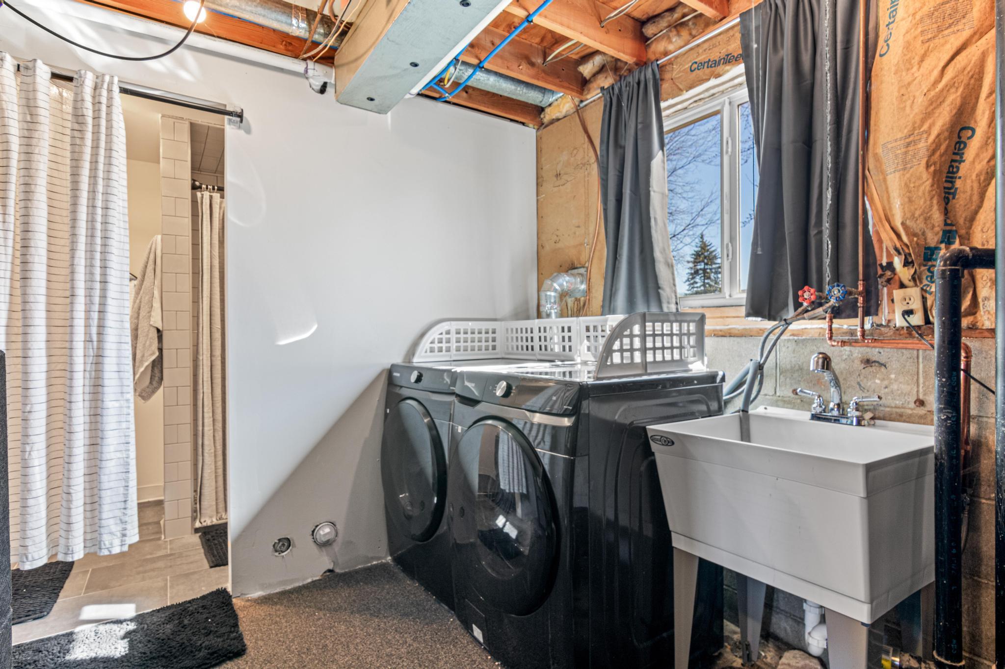 Newer washer/dryer and entry to basement 3/4 bathroom.