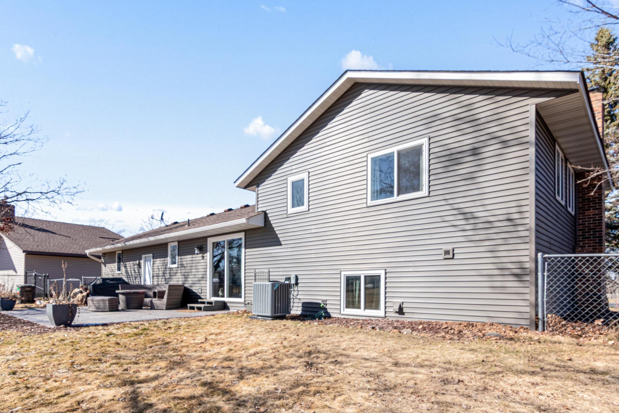 Rear of home - newer siding and stamped patio