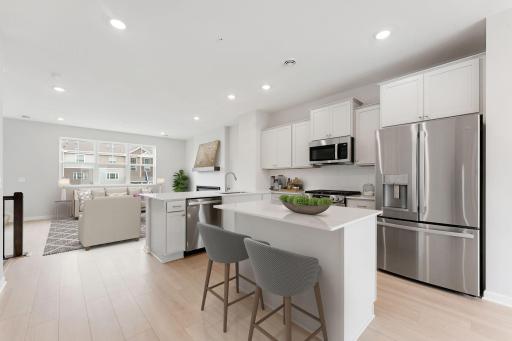 Light and bright! The finishes blend an elevated feel with functionality. The L-shaped kitchen with island and adjacent dining area make a perfect space for both everyday meals and entertaining.