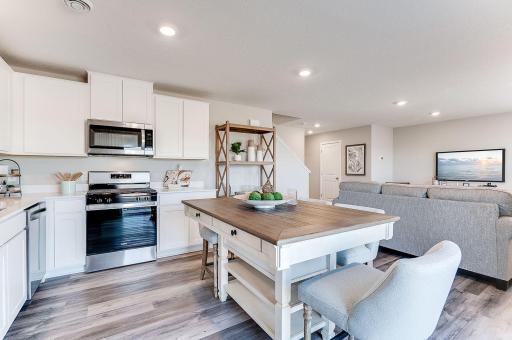 The main living space is open and full of light with an abundance of windows. (Model photo, colors may vary)