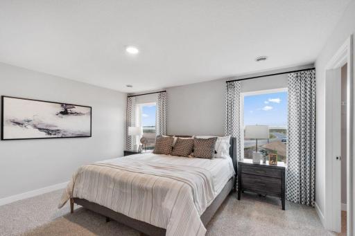 Private primary suite with room for a king size bed, dual vanities and oversized, walk-in closet. Photo is of model home. Colors and options may vary. Ask Sales Agent for details.