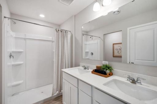 Private primary suite with room for a king size bed, dual vanities and oversized, walk-in closet. Photo is of model home. Colors and options may vary. Ask Sales Agent for details.
