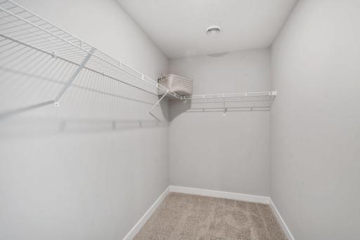 Private primary suite with room for a king size bed, dual vanities and oversized, walk-in closet. Photo is of model home. Colors and options may vary. Ask Sales Agent for details.