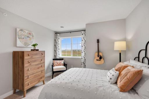 Two secondary bedrooms ideal for guests, office, or hobbies. Photo is of model home. Colors and options may vary. Ask Sales Agent for details.