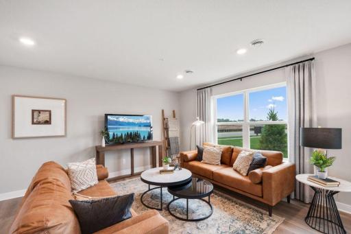 Light-filled living area with room to entertain and live. Photo is of model home. Colors and options may vary. Ask Sales Agent for details.