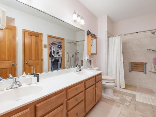 Double sinks and two showers. One is special walk in shower adapted for handicap access.