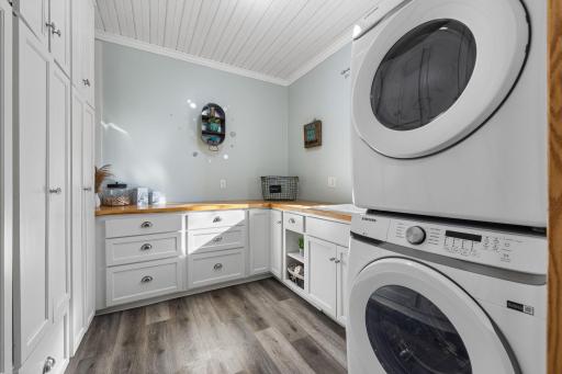 Who wouldn't love this laundry room with all these built-ins and folding spaces.