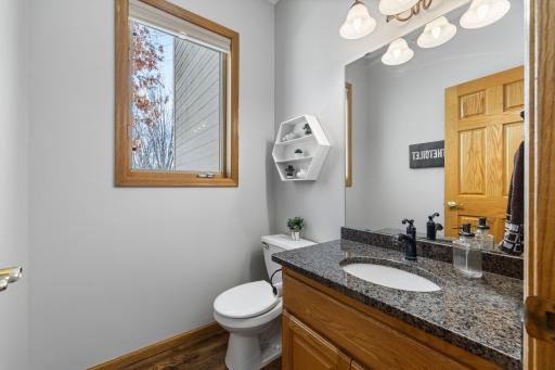 Updated guest bath boasts granite topped vanity.