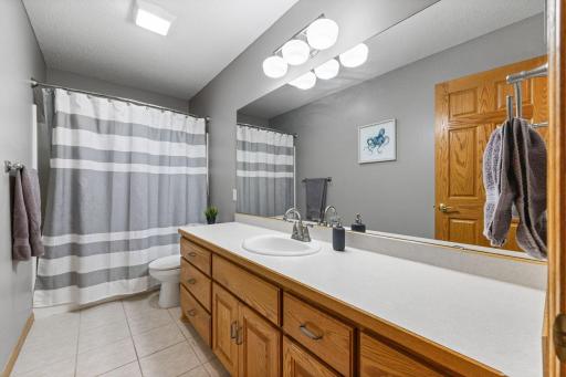 Full 2nd bath on upper level has large vanity and neutral design.