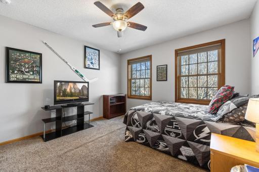 2nd of the 3 upper level bedrooms has ceiling fan and natural light from 2 windows.