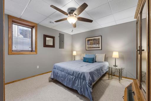 4th bedroom is spacious, features neutral decor and has ceiling fan.