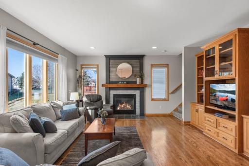 The sun-drenched living room boasts a lovely gas fireplace and great natural light.