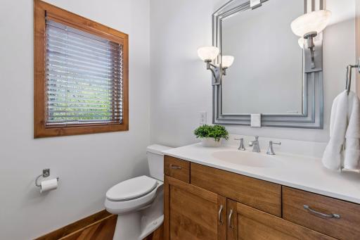 Main level powder room with hardwood flooring.