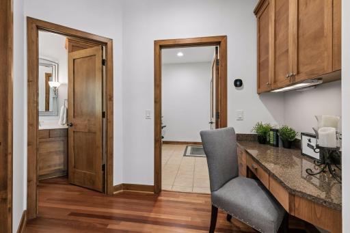 Built-in desk with granite counter / additional cabinetry, walk-in pantry and powder room are adjacent to the kitchen.