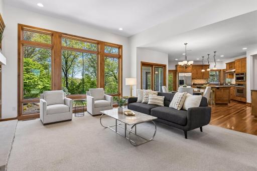 Light-filled and open, the main floor showcases spacious living areas and breathtaking views of the surrounding nature at every turn.