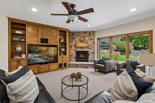 The inviting lower level family room is the perfect place to unwind, featuring alder built-ins & a cozy gas fireplace crafted with historic stones reclaimed from the St. Paul streetcar era - adding warmth, character, and a truly one-of-a-kind touch.